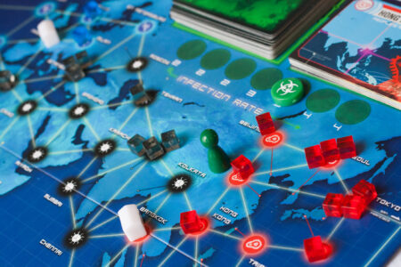 The cooperative board game Pandemic, designed by Matt Leacock, showing a world map with "virus cubes" spreading